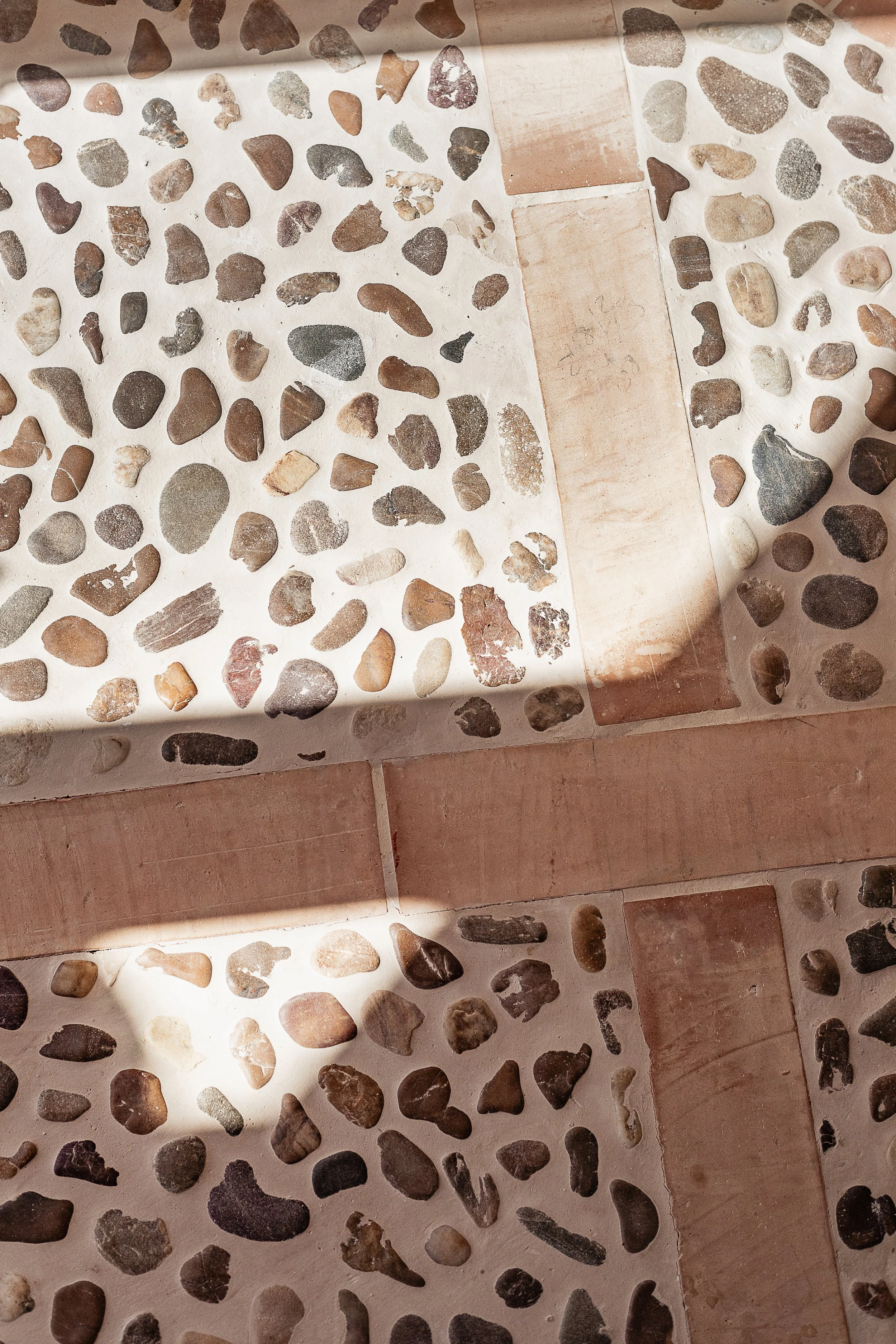 River stone floor showcasing handcrafted natural materials in a Mediterranean family home in Mallorca.