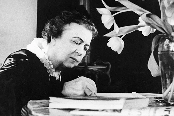 An older Alexandra Kollontai writing her memoirs