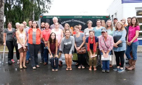 Members of the Greenbrier Valley Local Foods Initiative and community partners gather in front of a mobile market in Alderson, West Virginia