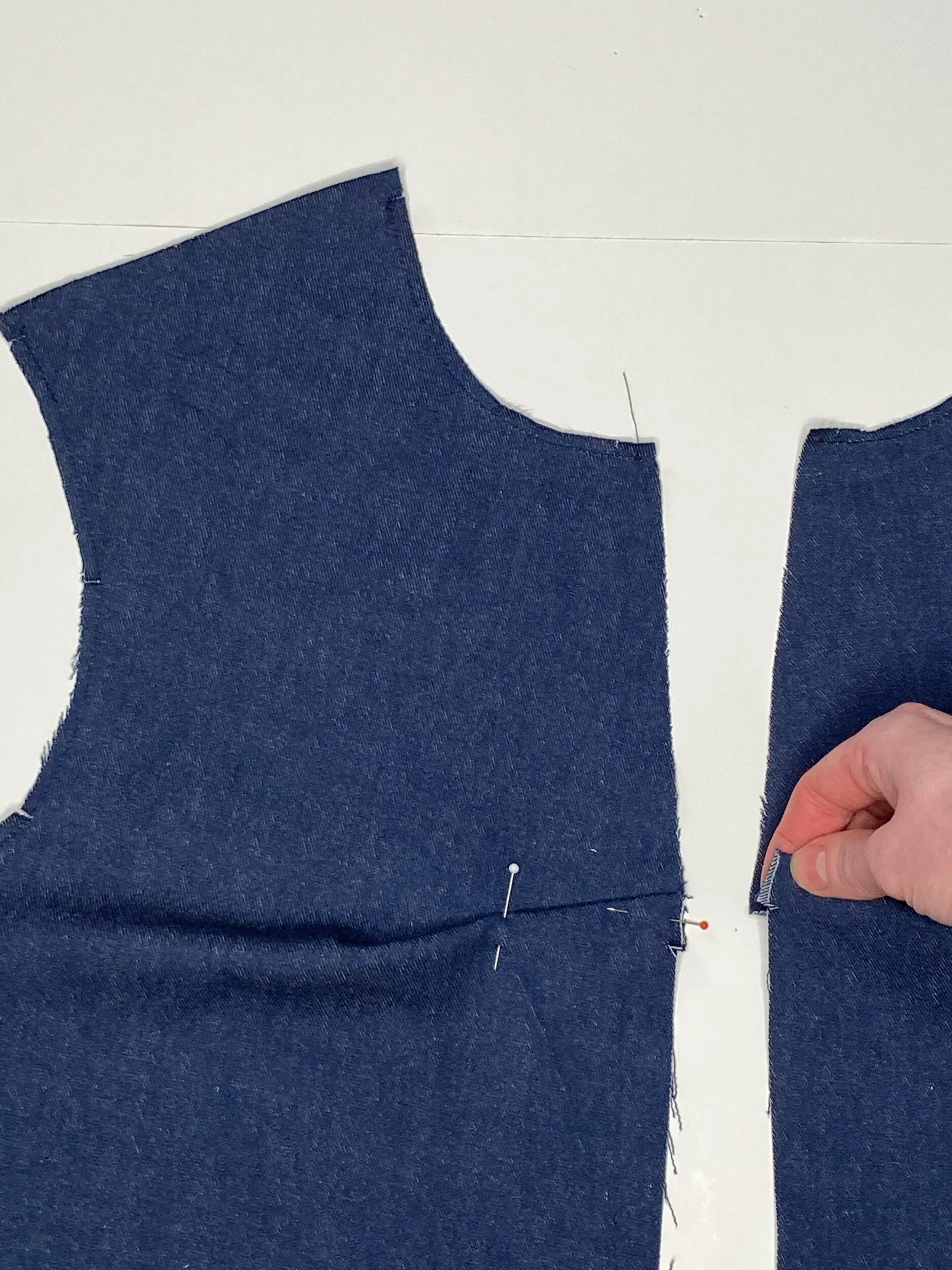 Once matched fold the tuck up, towards the neck and pin