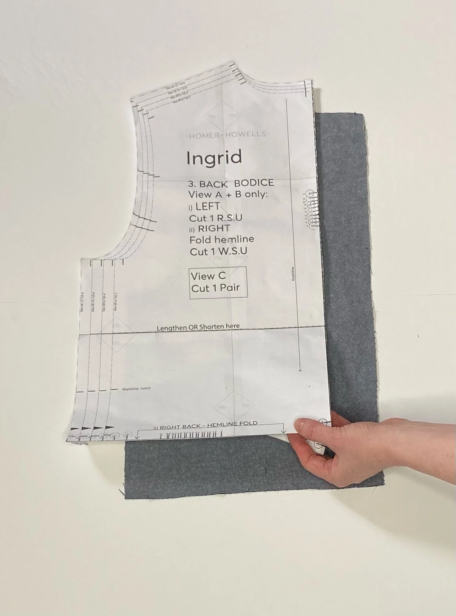 Then fold the pattern piece along the fold line, turn your fabric over to WSU (wrong side up) before cutting the second back bodice panel.