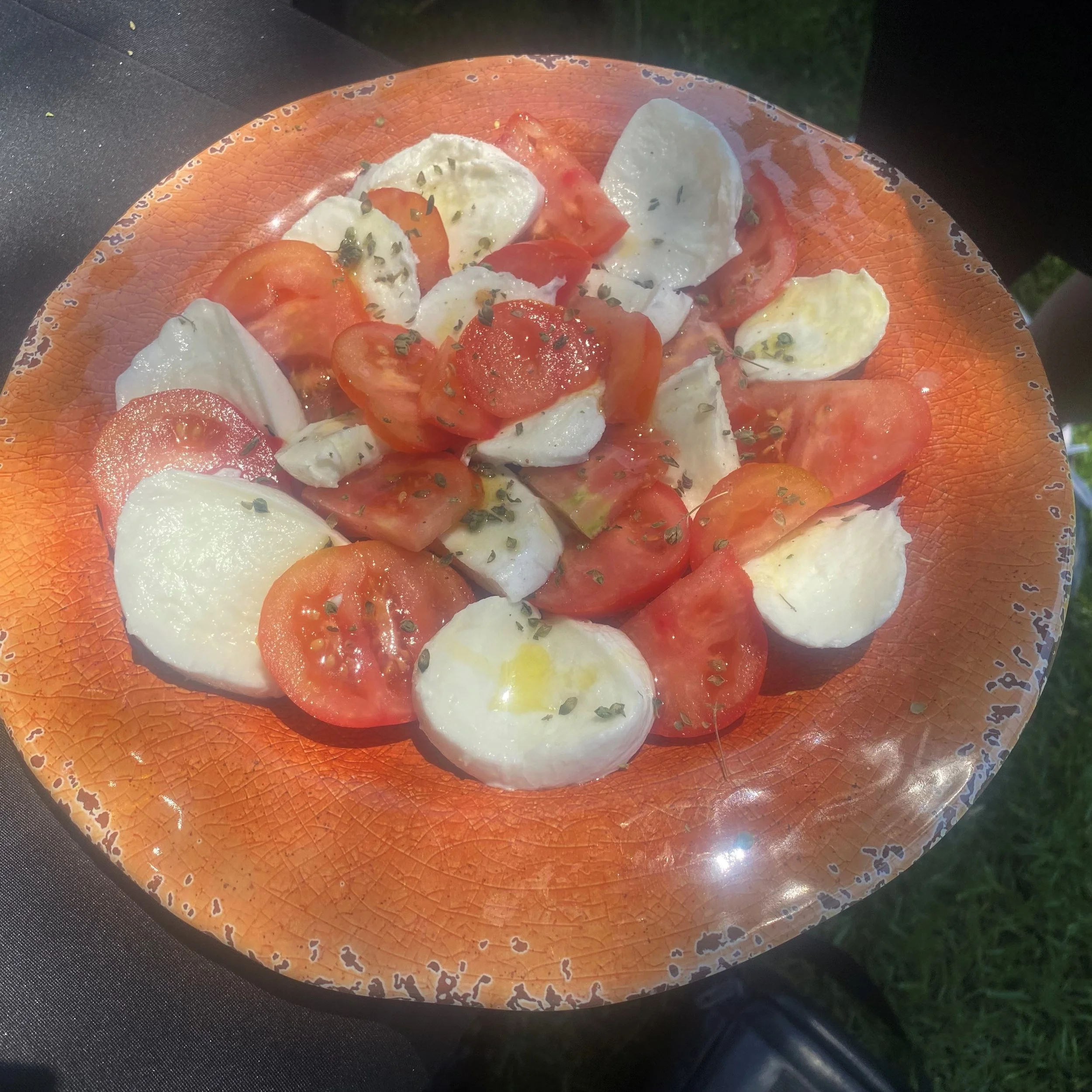 Imported Burrata was sliced and served with garden fresh tomatoes, a drizzle of olive oil, and sprinkled with fresh herbs. 