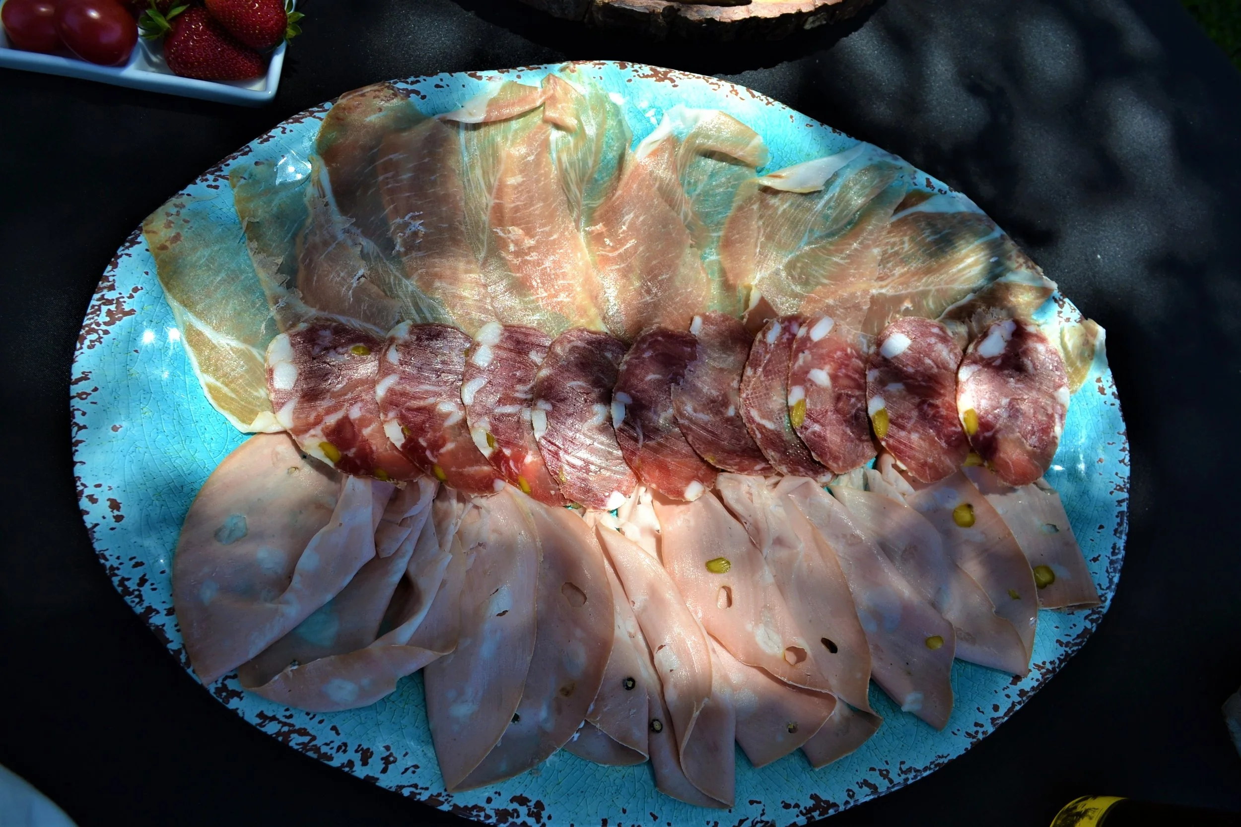  A platter of cured meats included prosciutto, salame with pistachios, and mortadella. 
