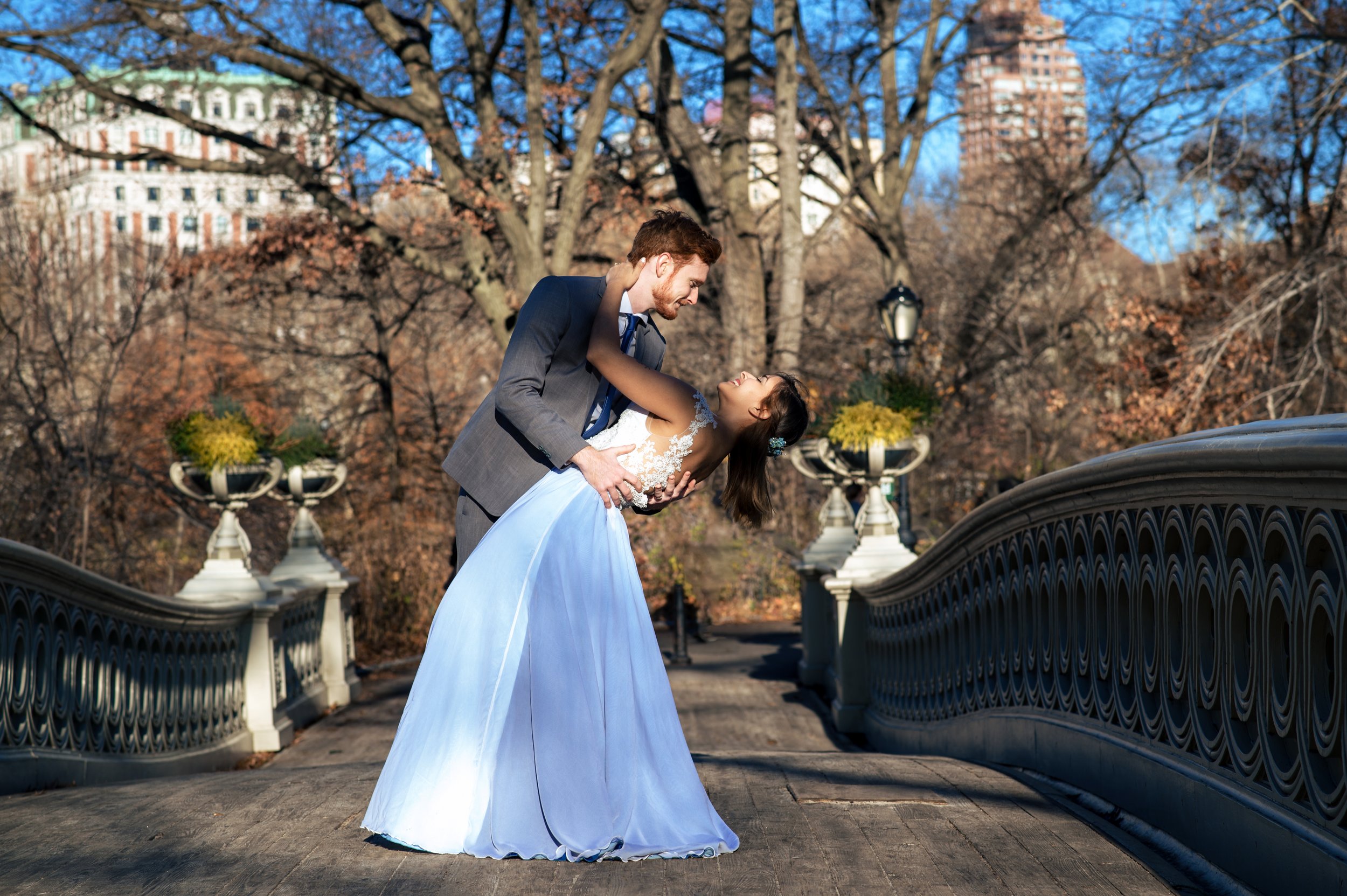 Young, mixed couple in their Wedding attire in Bow's Bridge, Central Park.jpg