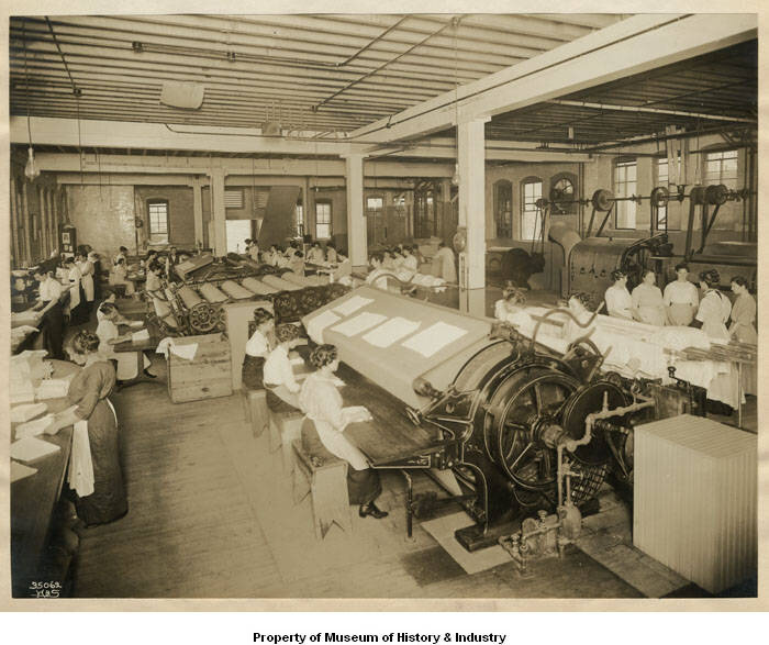 Women_pressing_and_folding_laundry_at_Supply_Laundry_Company_Seattle_1917.jpg
