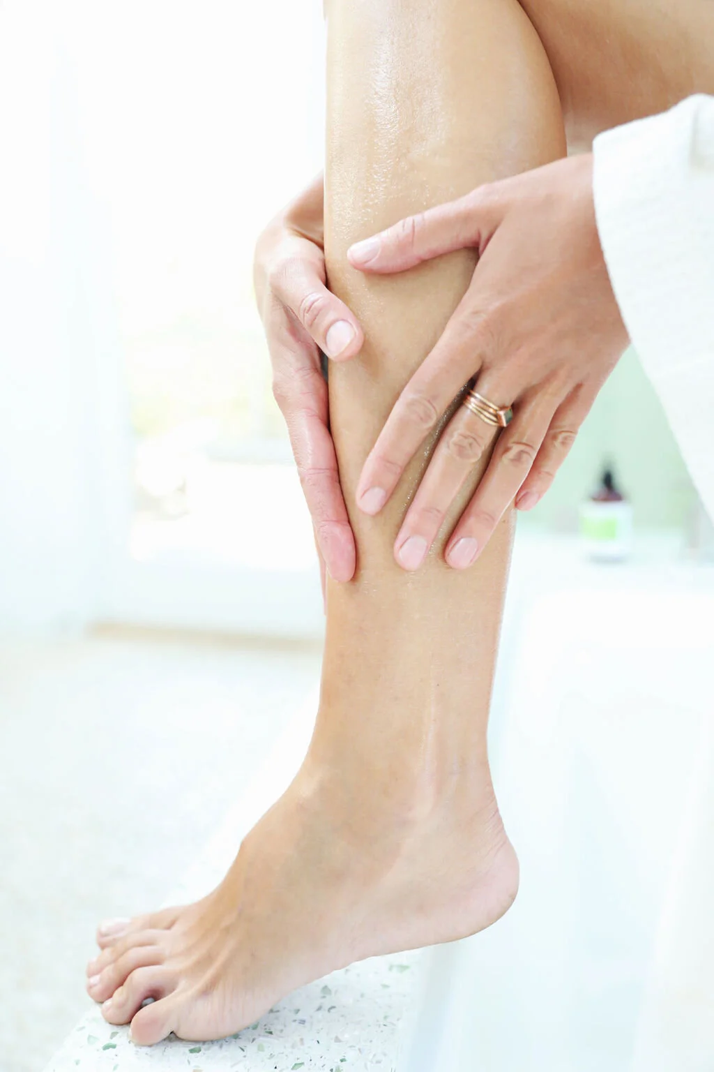Photograph of model applying The Balm to her legs Amanda Ross Skin Care is organic, natural, family owned, and made with love.