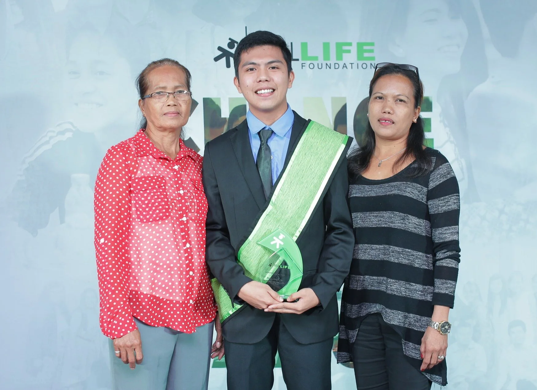 Joshua with his family receiving the Leadership Award at our North and Central Luzon Graduation last August 31, 2019