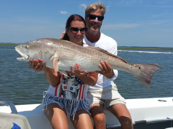 mighty-mako-fishing-couple-holding-fish.PNG