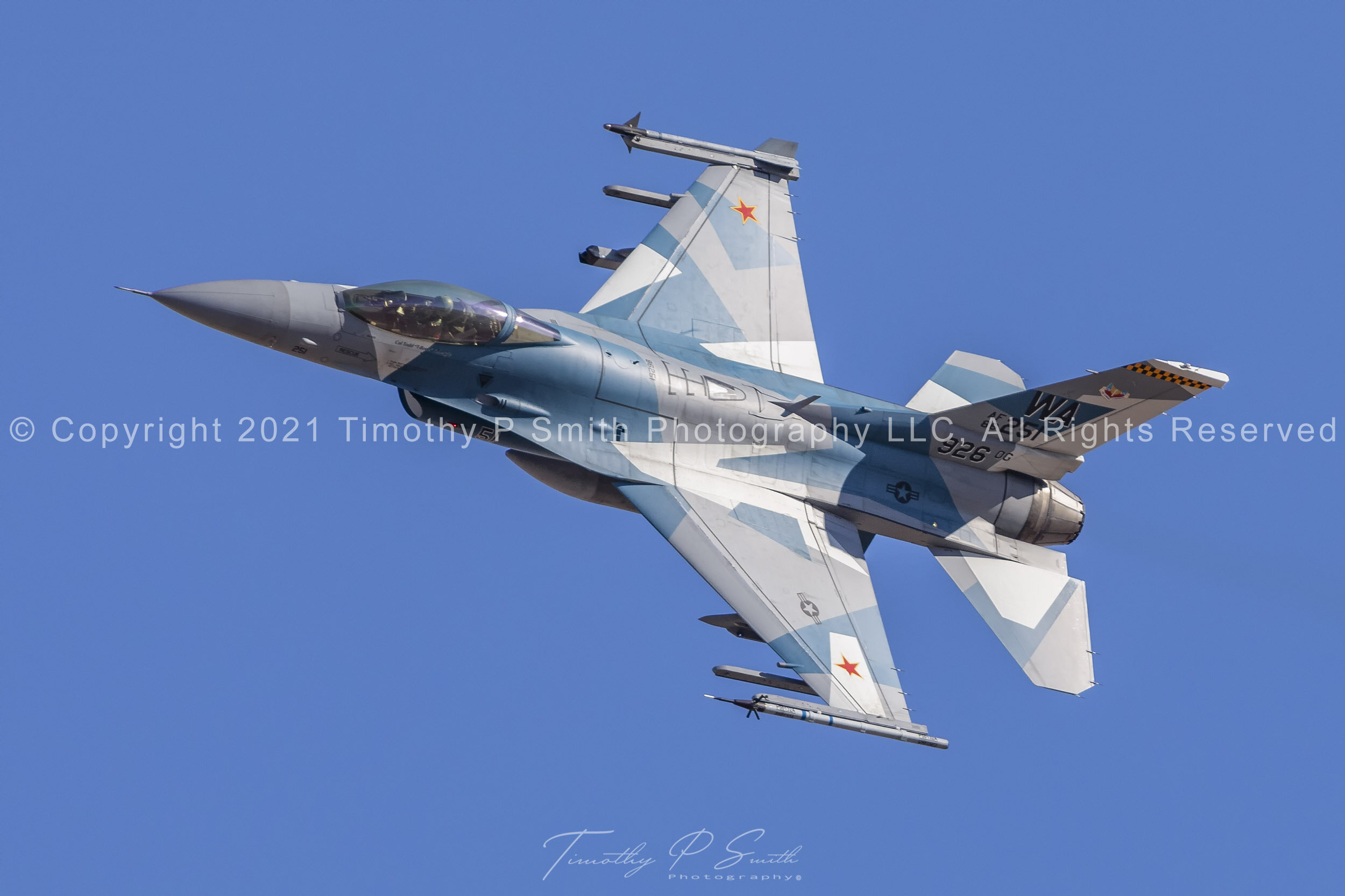 F-16C “Splinter” of the 64th Aggressor Squadron in flex departure from Nellis AFB, wearing angular camouflage inspired by Russian stealth fighters