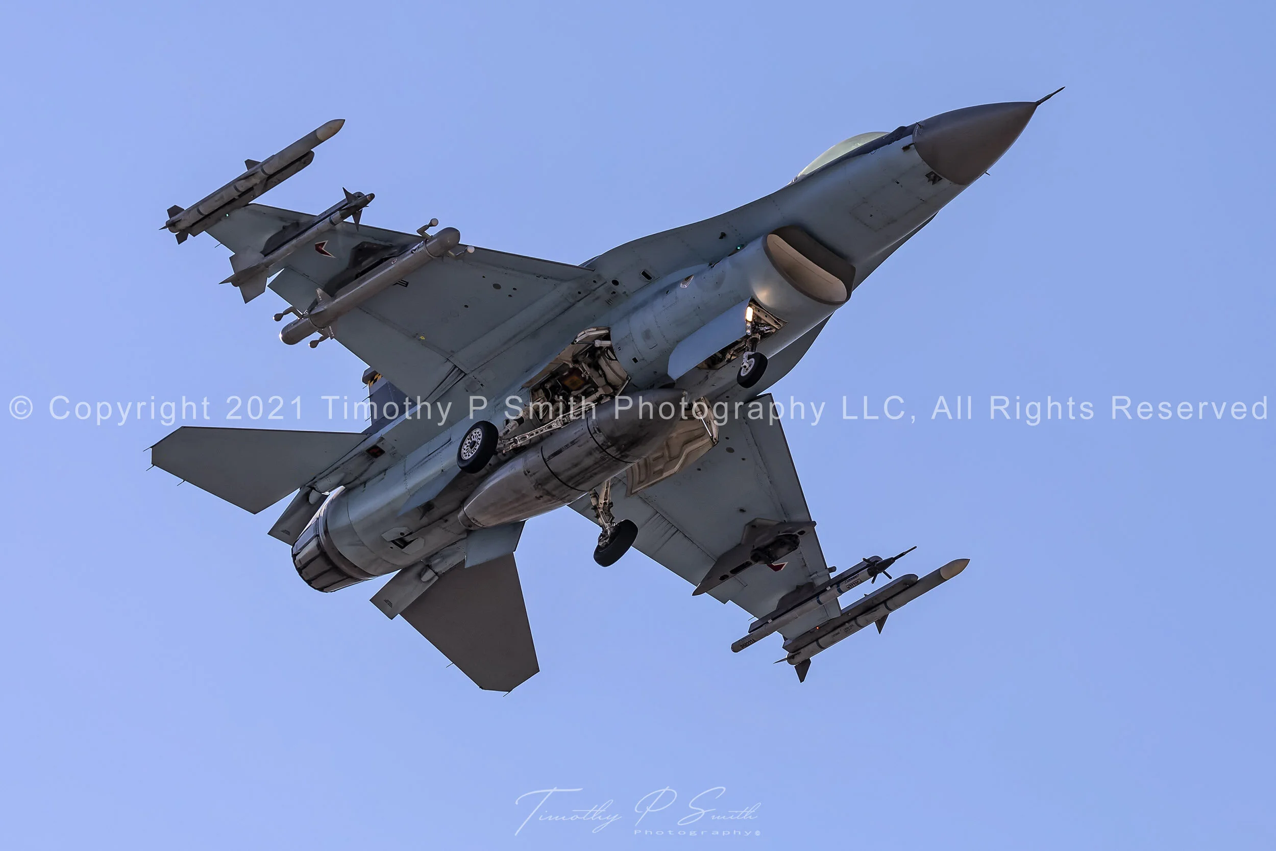 F-16 “Shark” of the 64th Aggressor Squadron on final approach to Nellis AFB in Su-57-inspired camouflage. Available in fine-art, metal, and acrylic prints