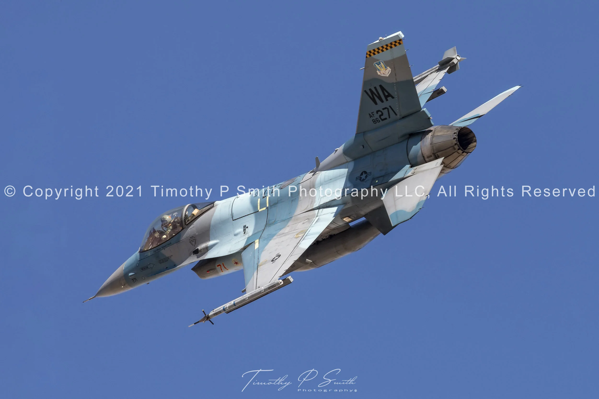 F-16C “Blue Flanker” of the 64th Aggressor Squadron in dynamic turn during flex departure from Nellis AFB, showing topside camo