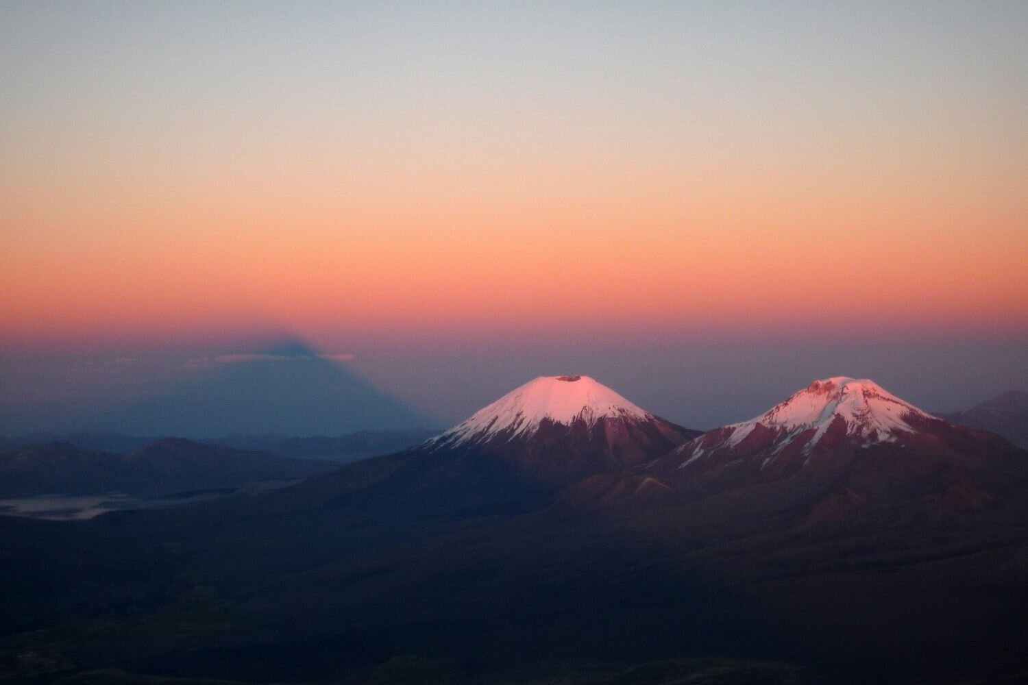  Sunrise with the shade of Nevado Sajama and the Parinacota and Pomerape volcanoes. Taken during the climb of Sajama. Bolivia 