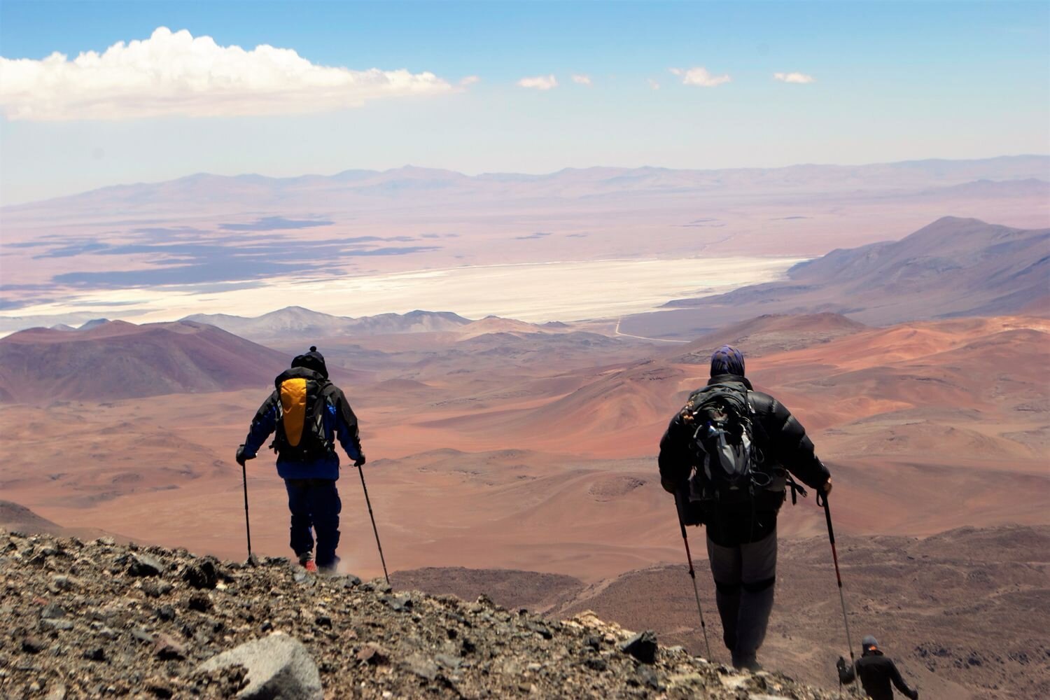  Team of climbers on an acclimatizing hike in the Chilean altiplano, with Atacama salt flat in the back ground. Chile 