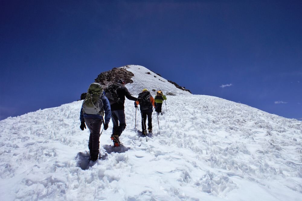  Team of climbers on the glacier leading to Acotango summit. 