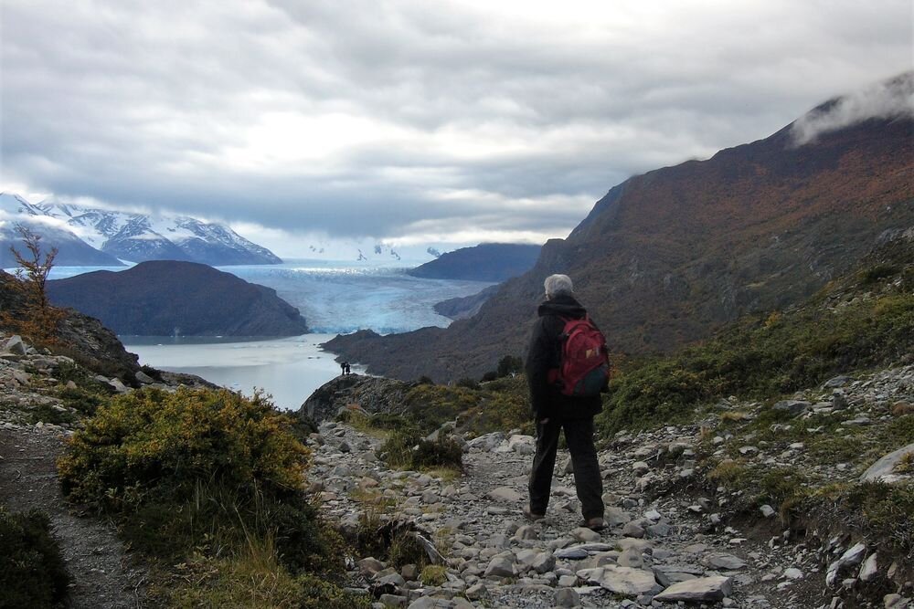  A hiker approaching Lake Grey. Torres del Paine National Park. Chile. 