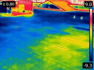 Infrared view of water trapped under a flat roof. The yellow and red areas are actually the water since it was the warmer area.
