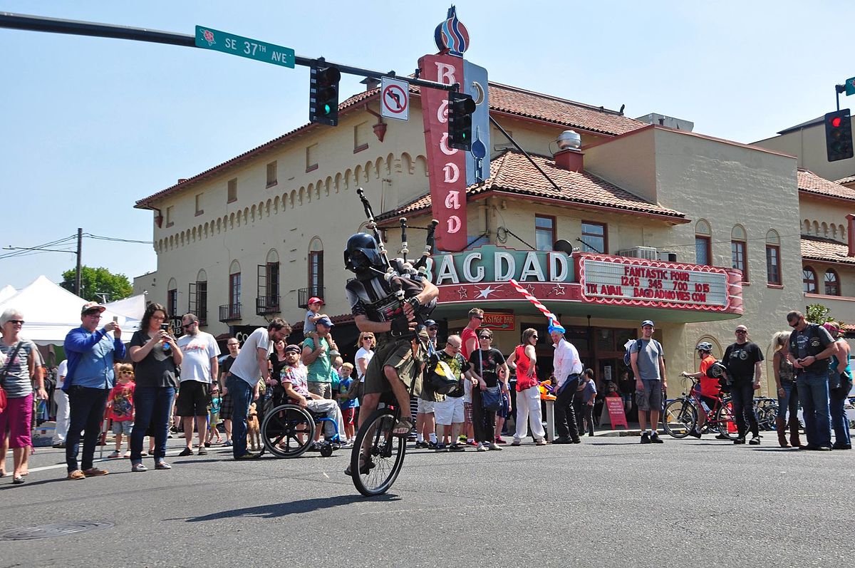 The_Unipiper_entertaining_a_crowd_gathered_in_front_of_the_Bagdad_Theater_in_Portland,_Oregon.jpg
