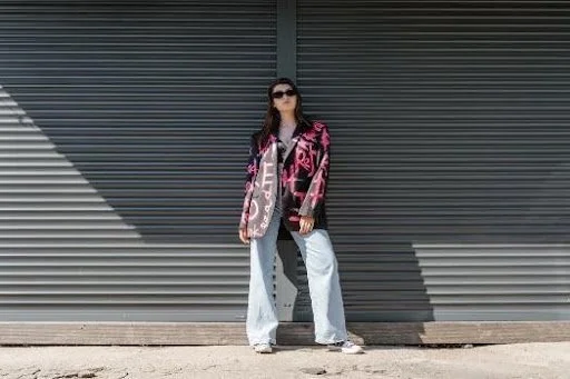 a young woman in an oversized blazer