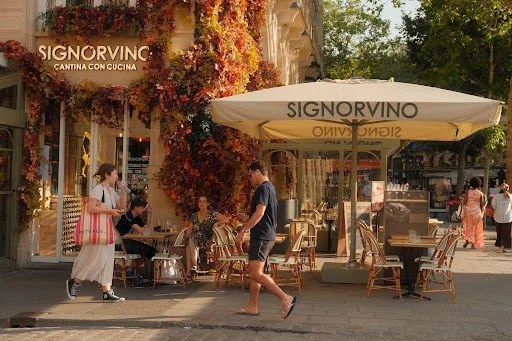 Packed suitcase of merino knits, cotton shirts and leather boots for two weeks in Italy
