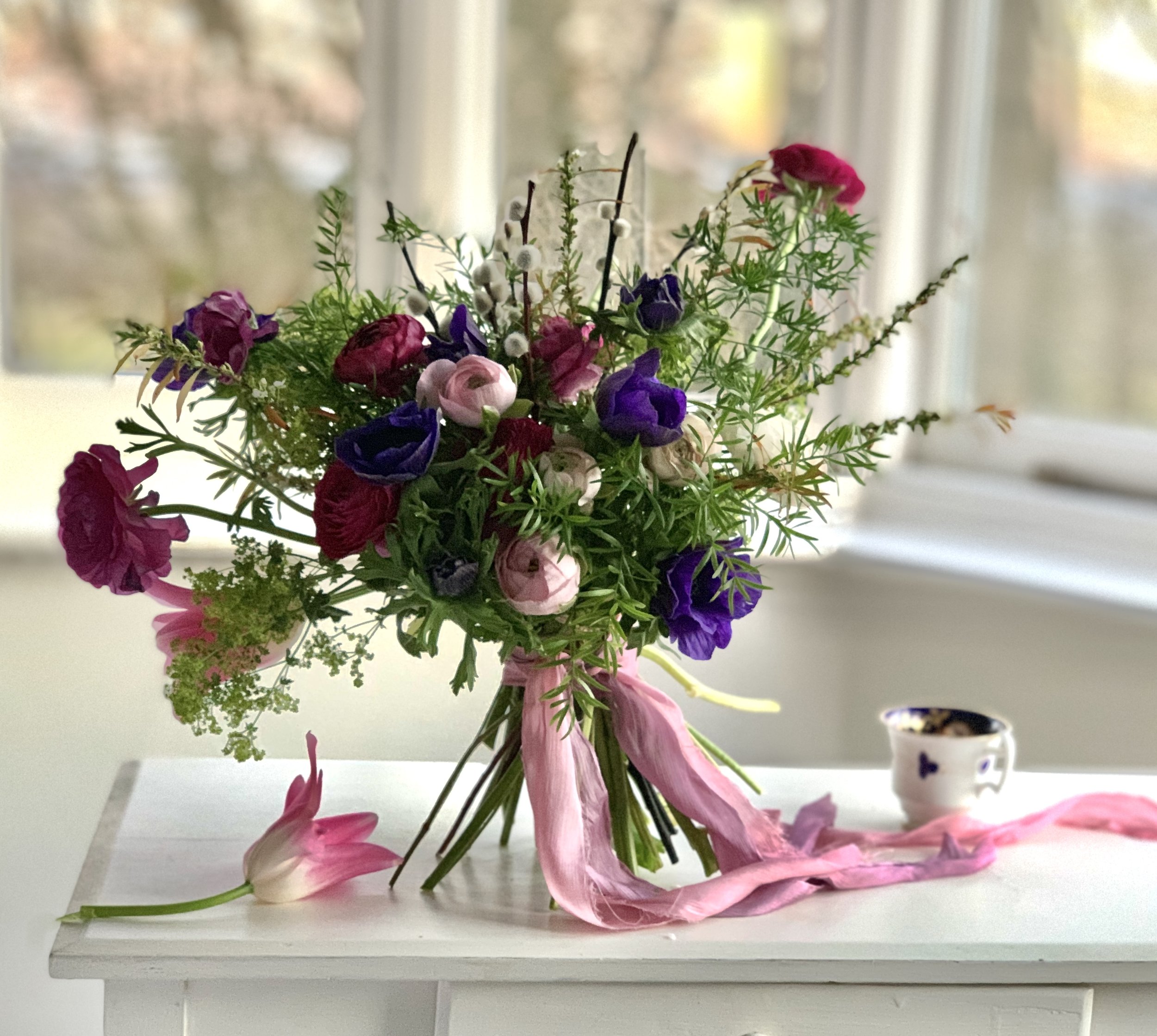 Anemone and ranunculus pinks and purples in bay window.jpg