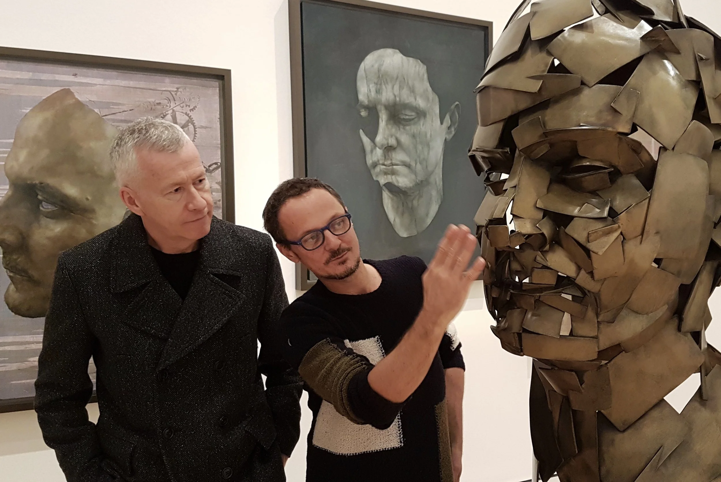Jonathan Yeo shows John a bronze self portrait he made using a virtual paintbrush and digital 3D scanning technology. Photo Jerome Weatherald