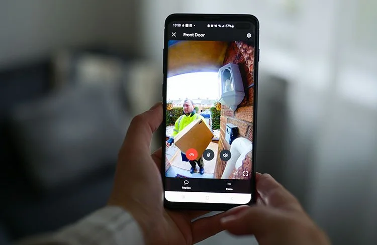Homeowner viewing a delivery person through a video doorbell security camera on a smartphone in Greenville, SC