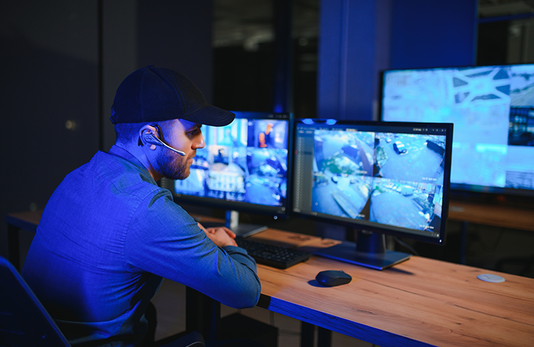 Security professional monitoring surveillance cameras.