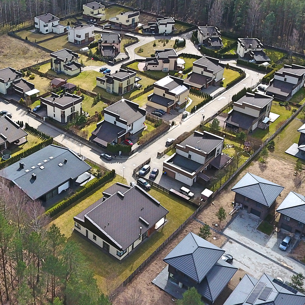 Aerial view of homes surrounded by trees.