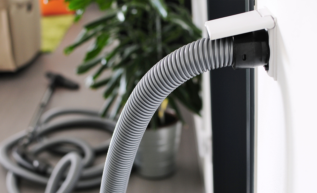 Built-in central vacuum hose connected to a wall inlet in a Greenville, SC home