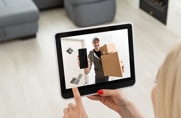 Delivery man viewed on a tablet at home.