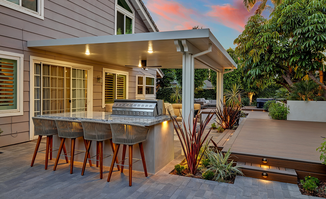 Modern outdoor kitchen and backyard entertaining area.