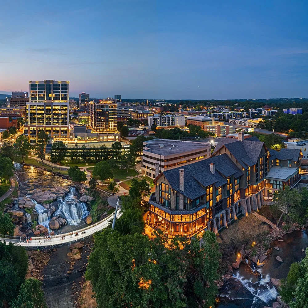 Downtown Greenville, SC skyline overlooking the Reedy River and Falls Park at dusk