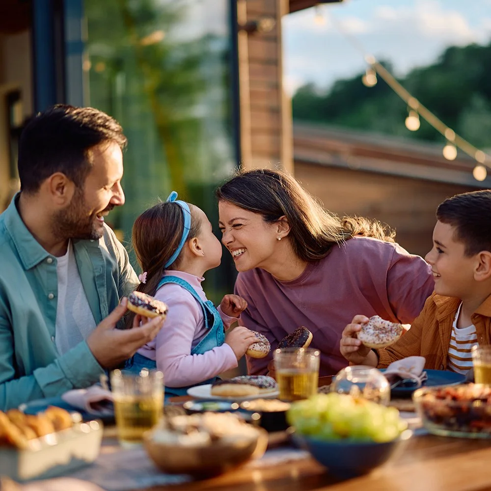 Family enjoying an outdoor meal together on a backyard patio in Spartanburg, SC.