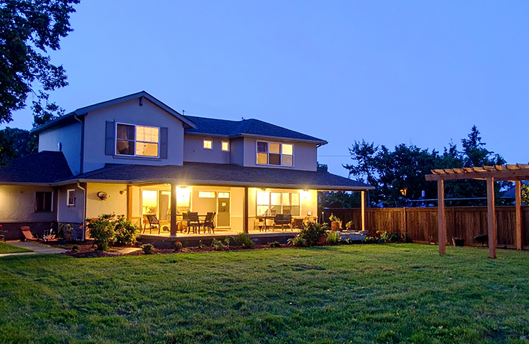 Modern home illuminated at night.