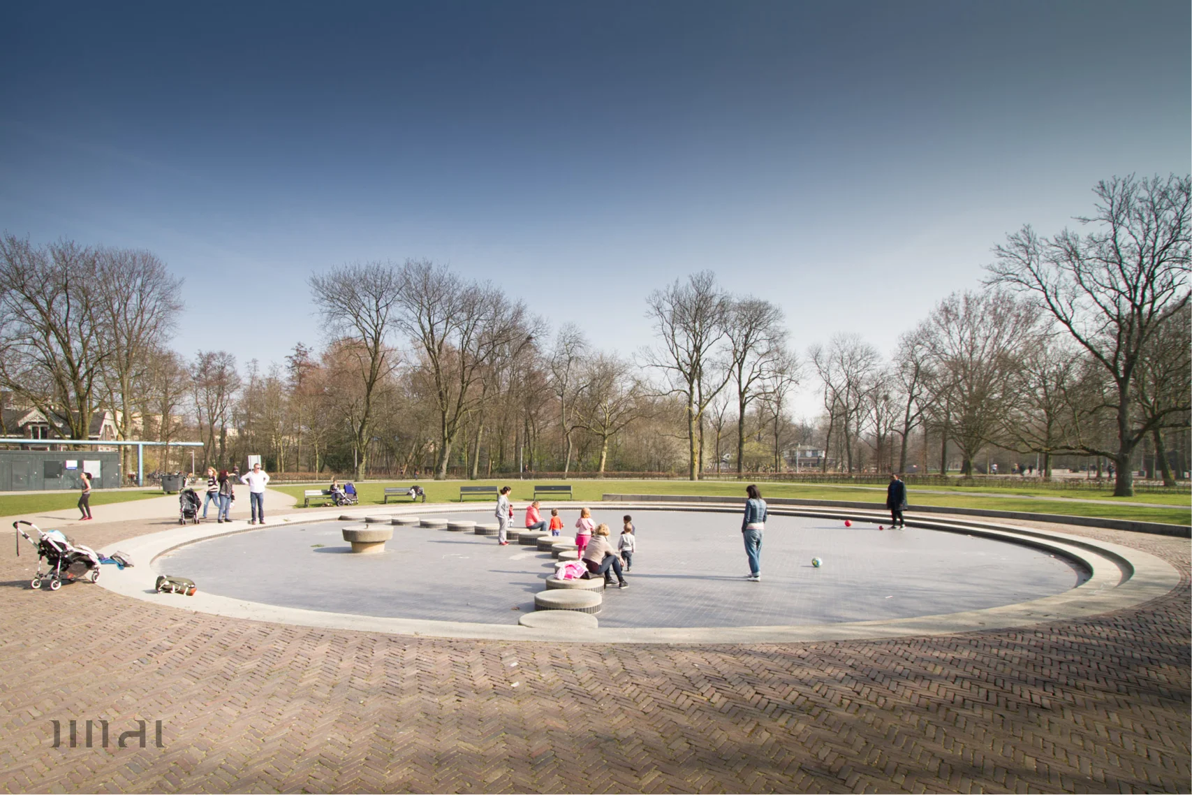 Large circular basin in Vondelpark with a series of stepping stones. In summer this is filled with to a shallow depth with water. Its still a popular space without water all thats needed is a ball.