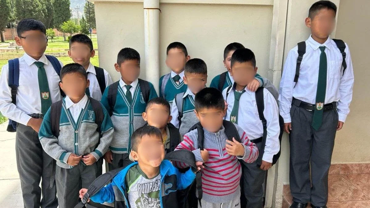 children in uniforms posing for picture
