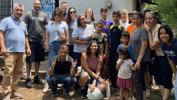 Missionaries during outreach with food posing in front of camera
