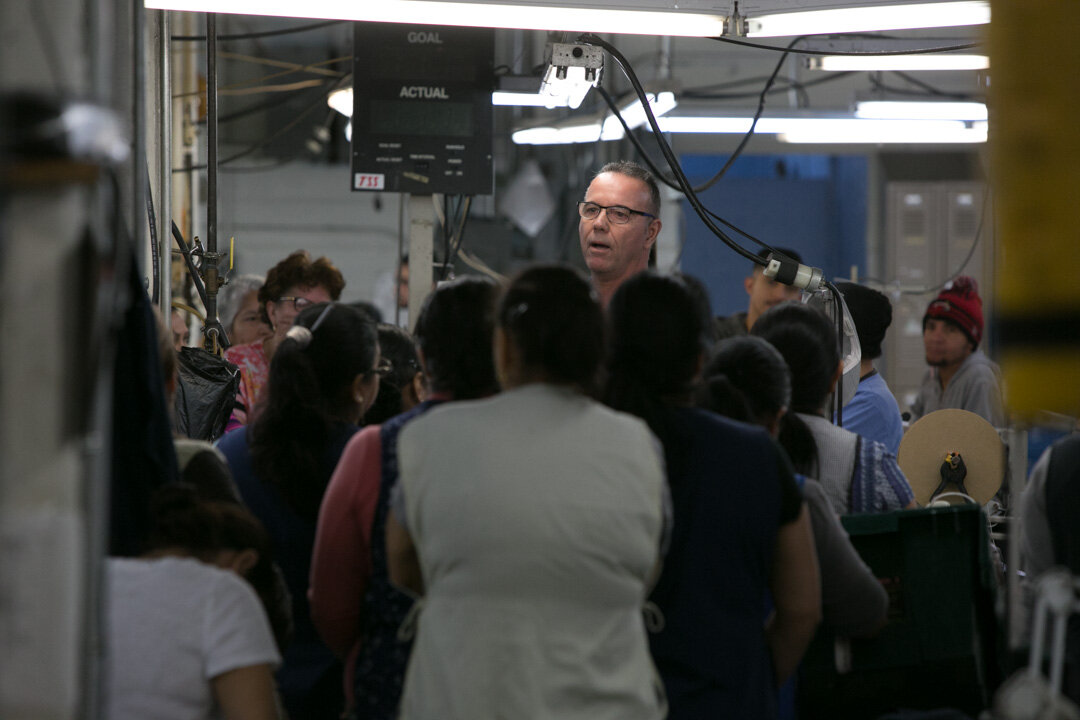 José Bellon, VP of Operations, meets with the factory staff.