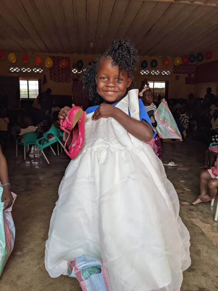 Marie is grateful for her new shoes and dress. Thank you Hebel School!