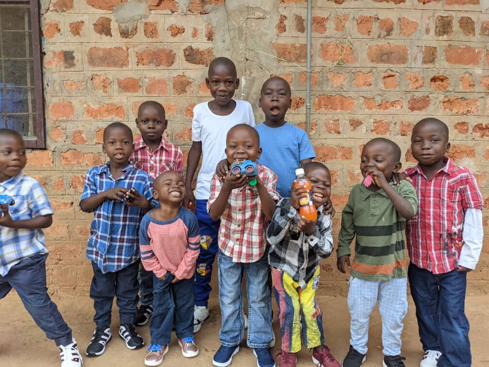 The boys are grateful for their gifts of shoes, clothing and small toys. Thank you Hebel School!
