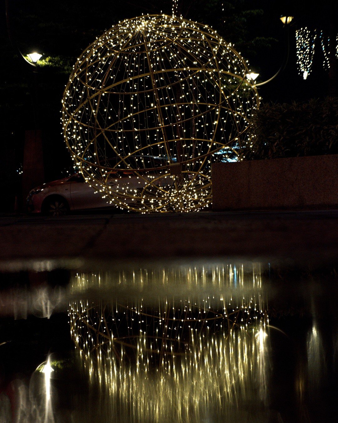 I am really glad that in the evening of the day was raining. It creates puddles which is a great way to produce reflection shot. Not as clean as I would hope for.	

#refraction #shootthroughwater #lightrefraction #lights #sunwaypyramid #street #stree