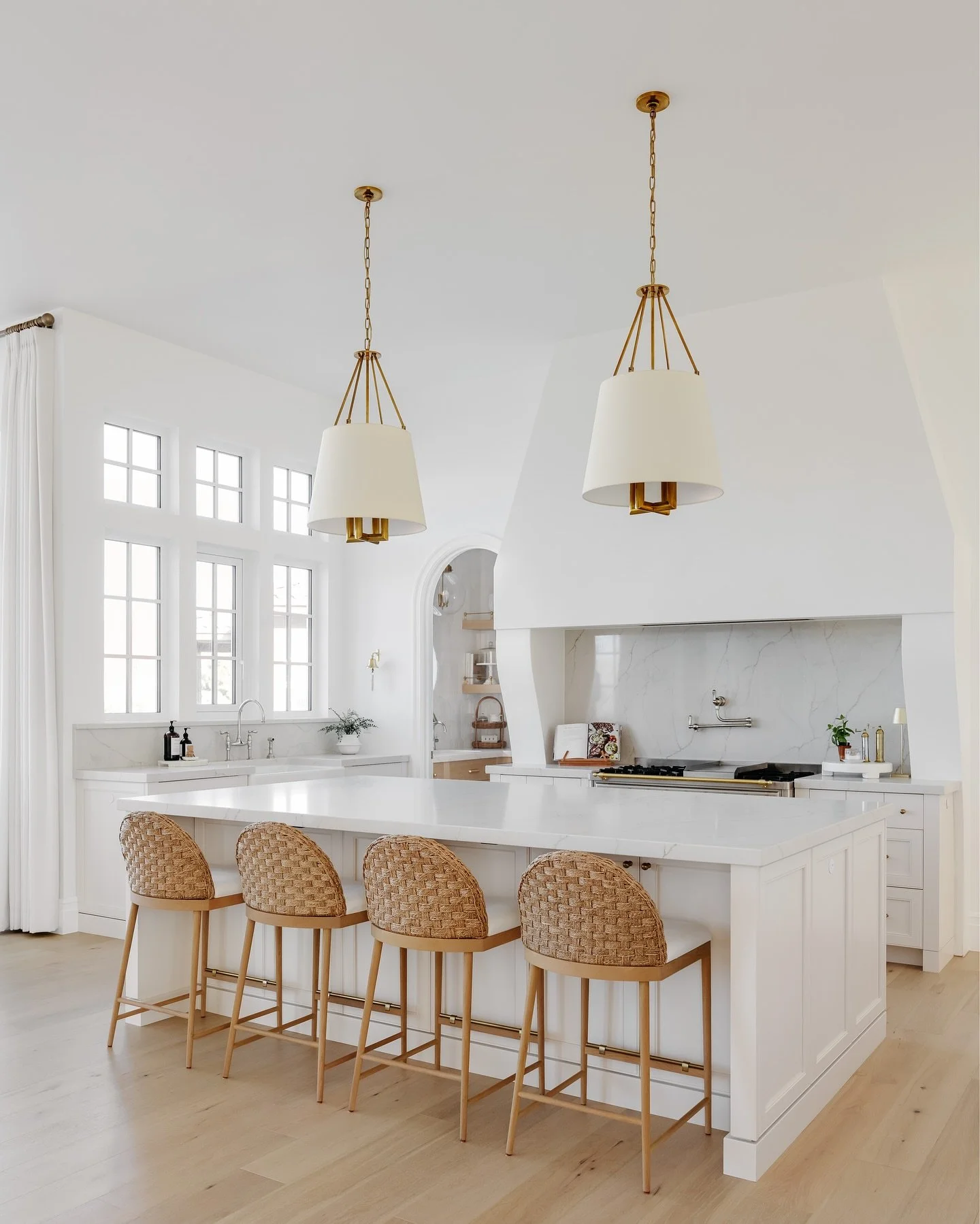 A hood that makes a statement, woven stools for texture, a charming pantry door, a beautiful range that could convince me to cook on the regular&hellip; Every angle of this kitchen is a must see.
