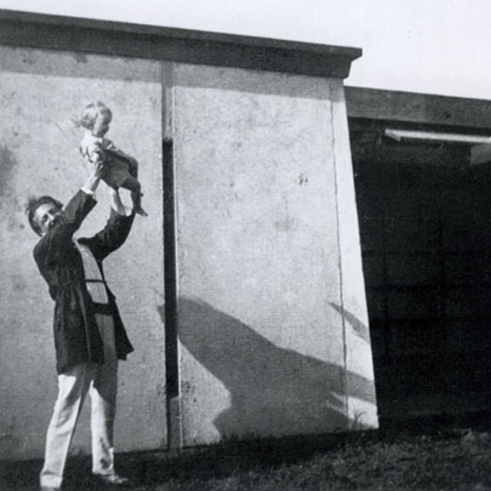 Schindler at his home and studio, the Kings Road House, holding Richard and Dion Neutra’s son, Dion. A pinwheel shape to house two families, the Neutras lived at the Kings Road House upon their arrival to LA in the mid 1920s until 1930.