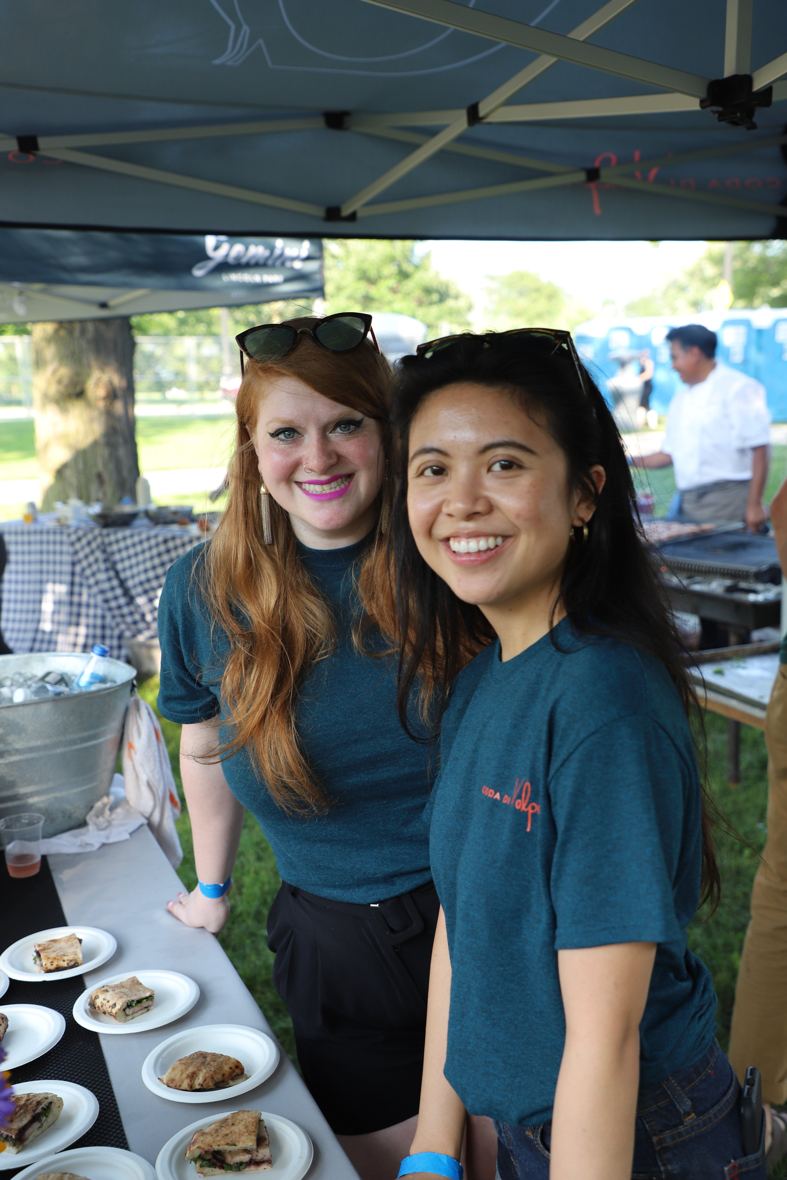 Servers at an off-site venue, serving small bites from Coda di Volpe to the community