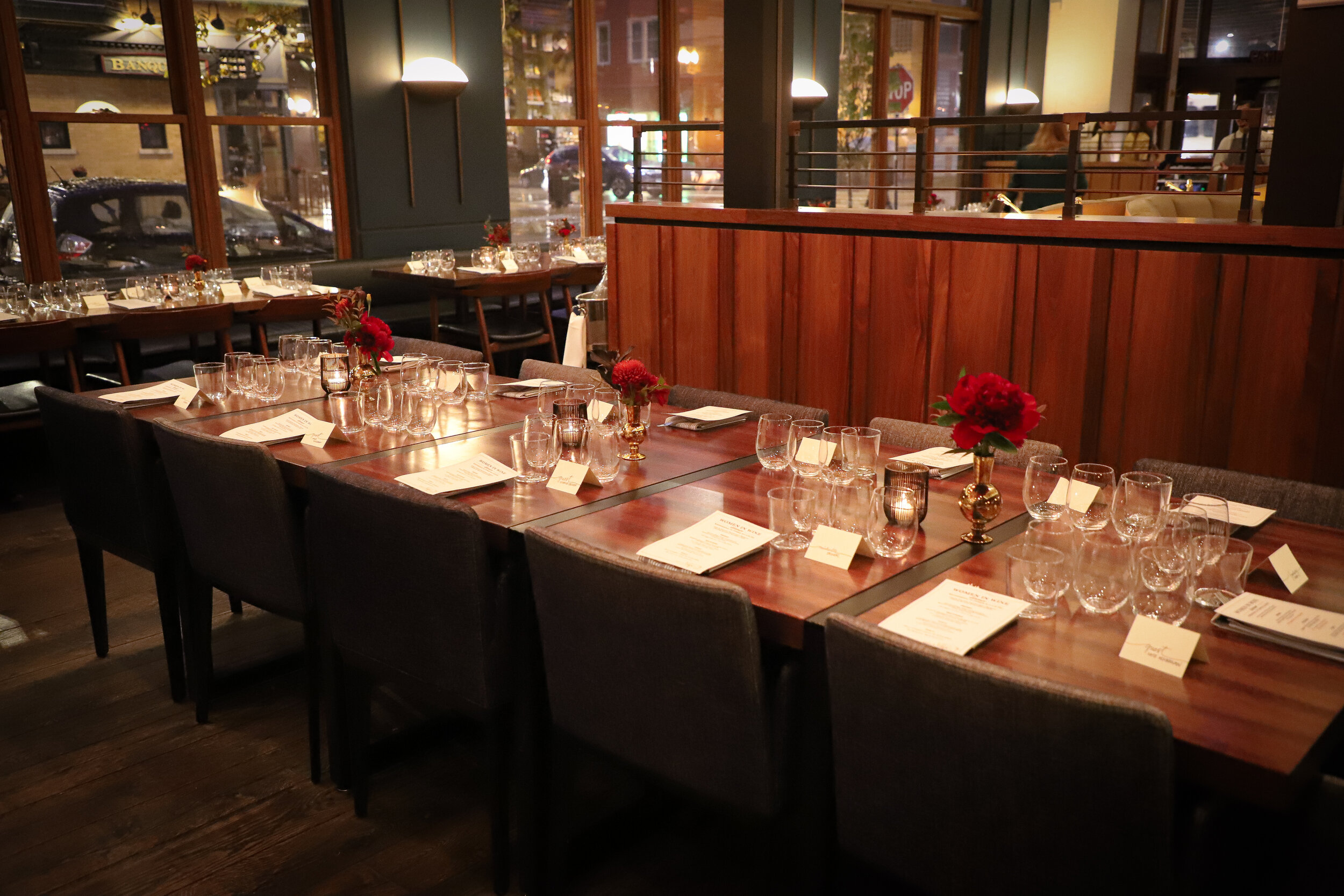 Head table adorned with beautiful flowers, set up for a special dinner.