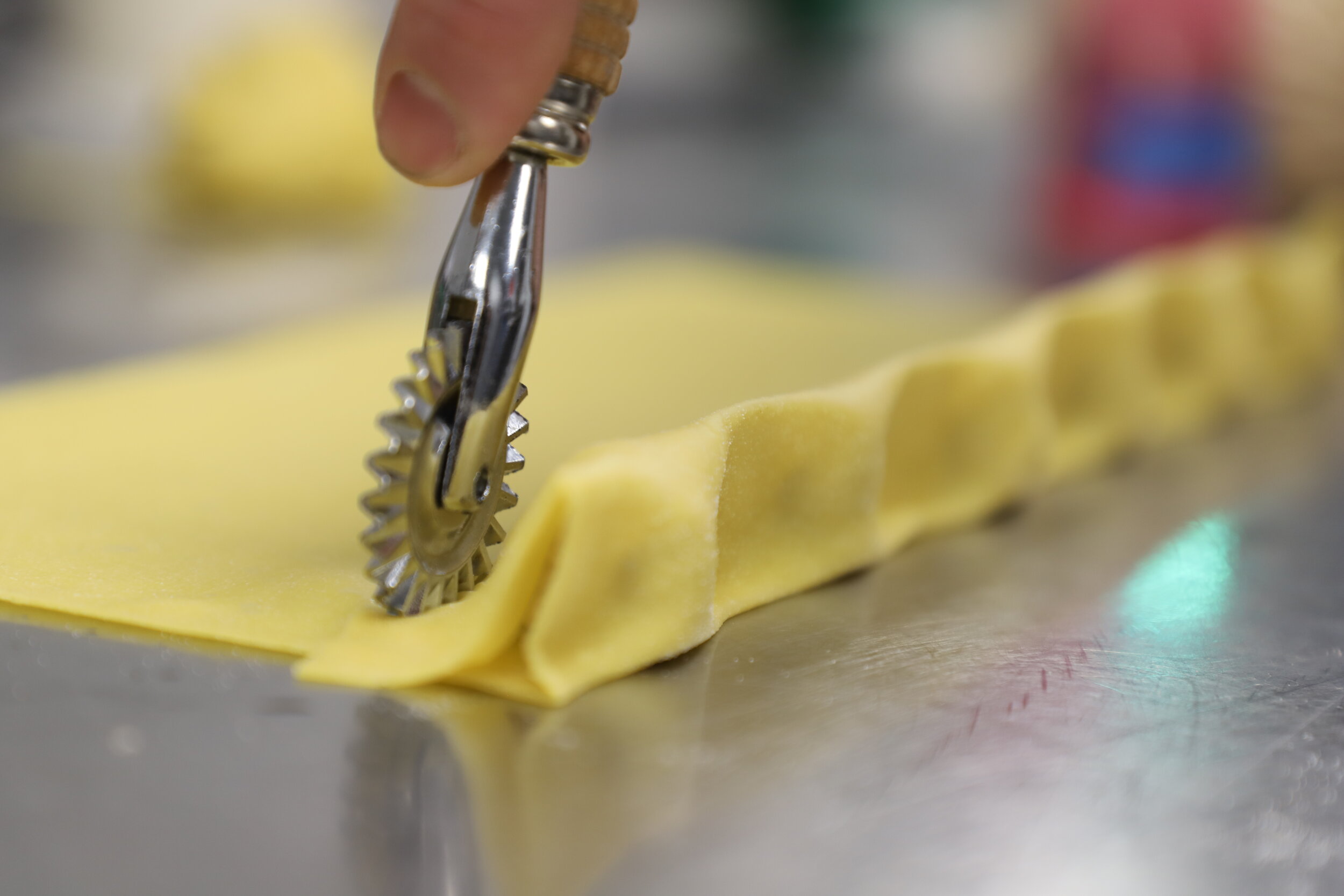 Handmade pasta being filled and cut