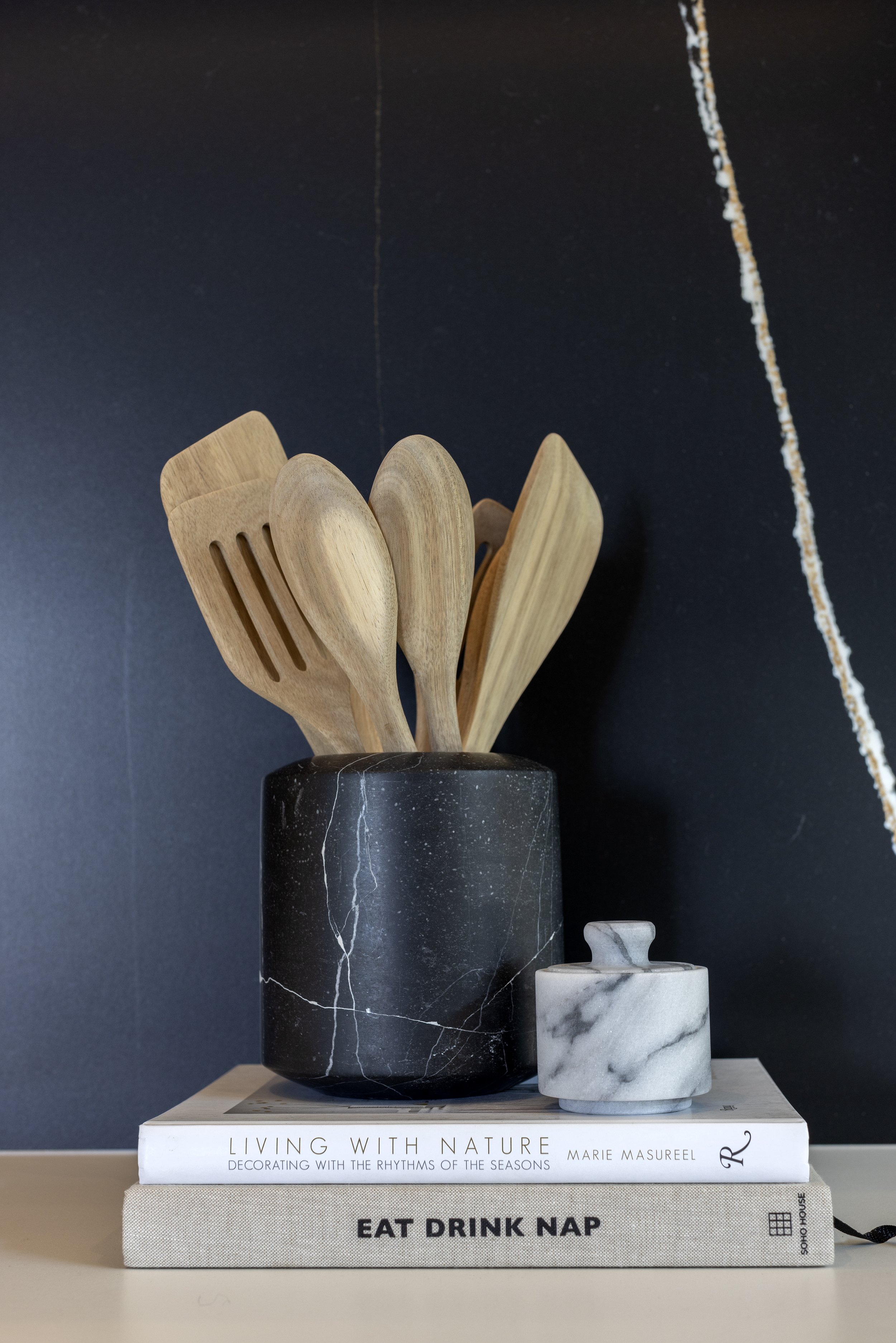 Wooden spoons in black vase