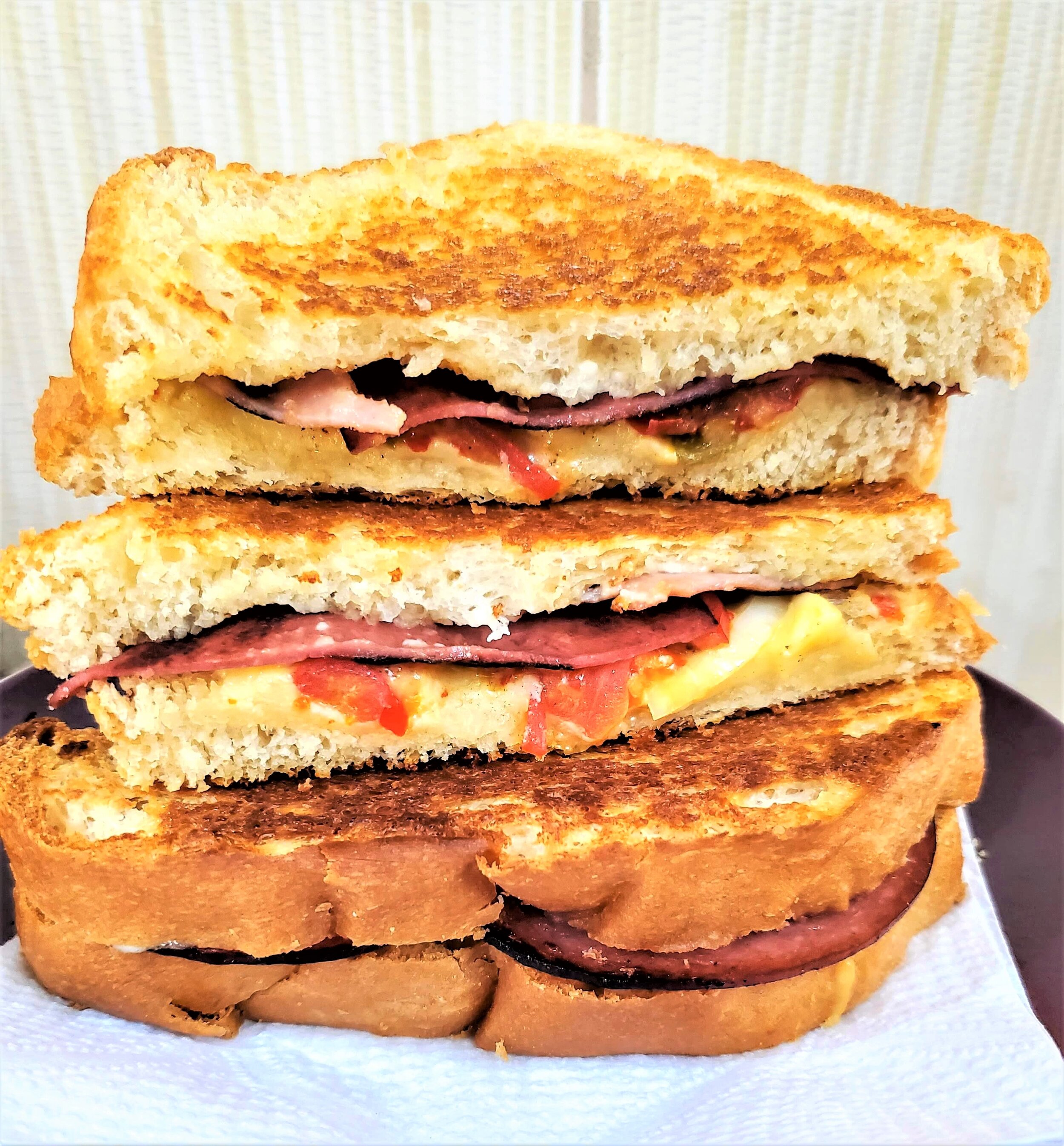 One of my favourite sandwiches! Grilled cheese with fried sausages, tomatoes, onions, pepper sauce and honey mustard!