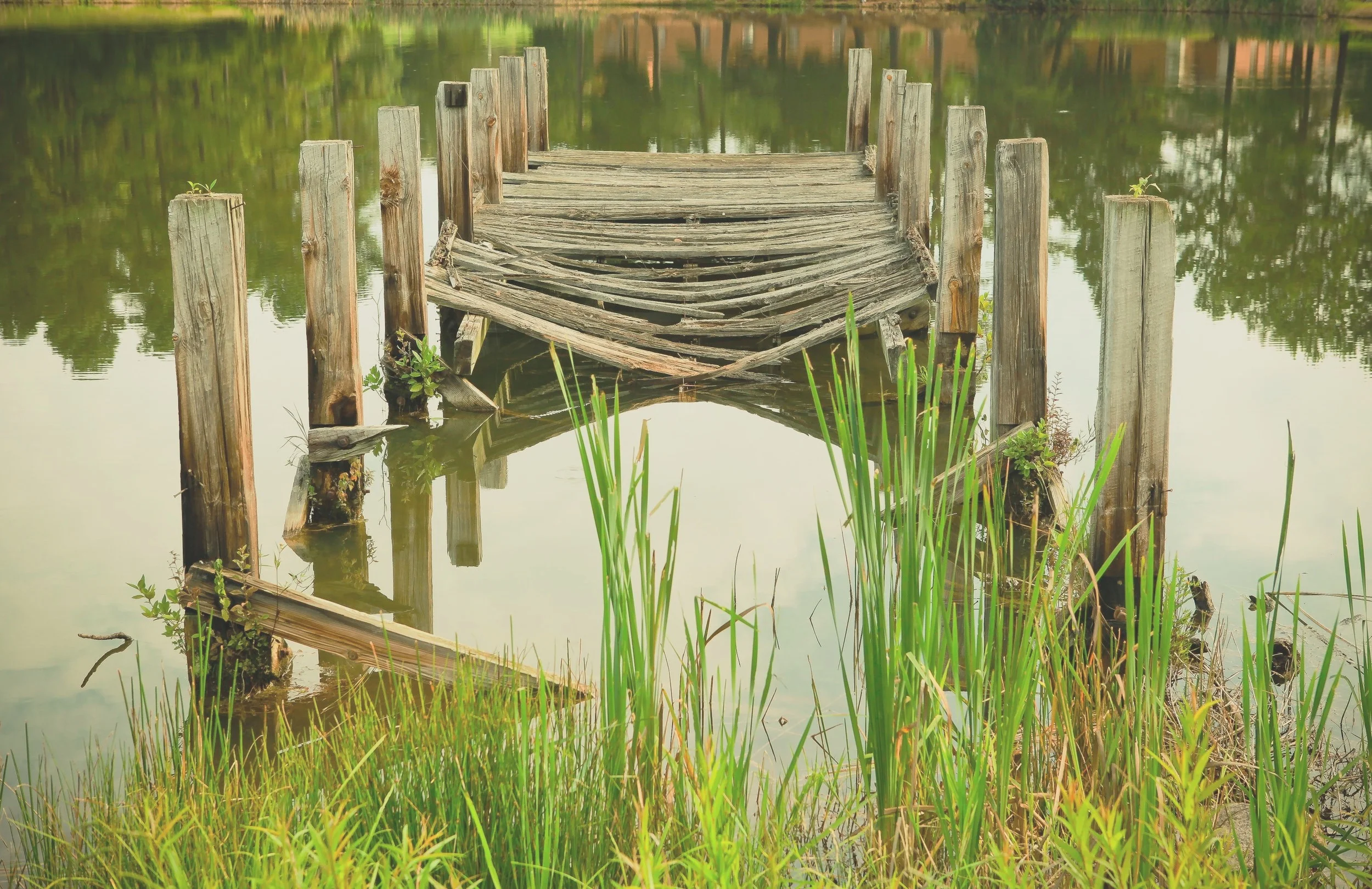 deck on lake with broken wood