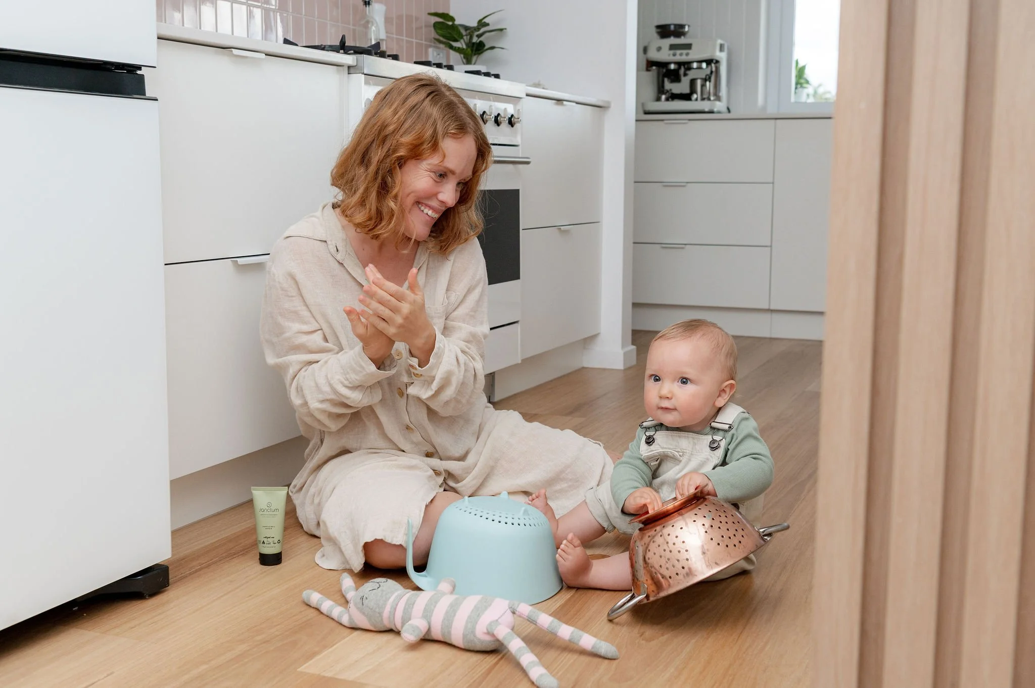 Mum and toddler playing together during a lifestyle skincare photoshoot at home